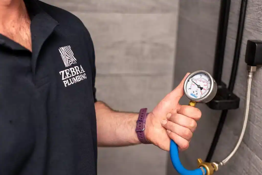 Gas plumbing pressure testing with a manometer for safety and compliance.