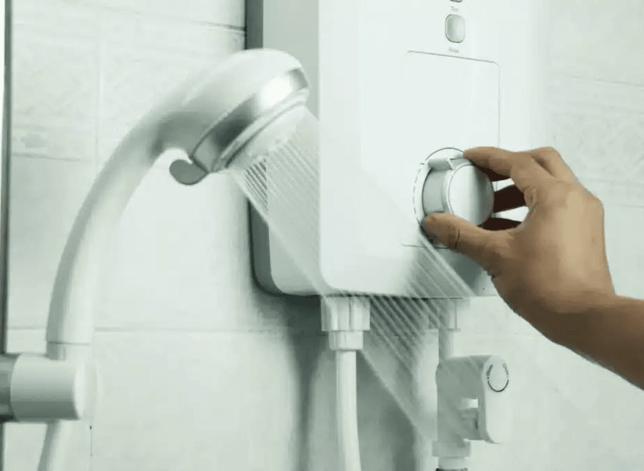 Hand adjusting shower hot water control panel.