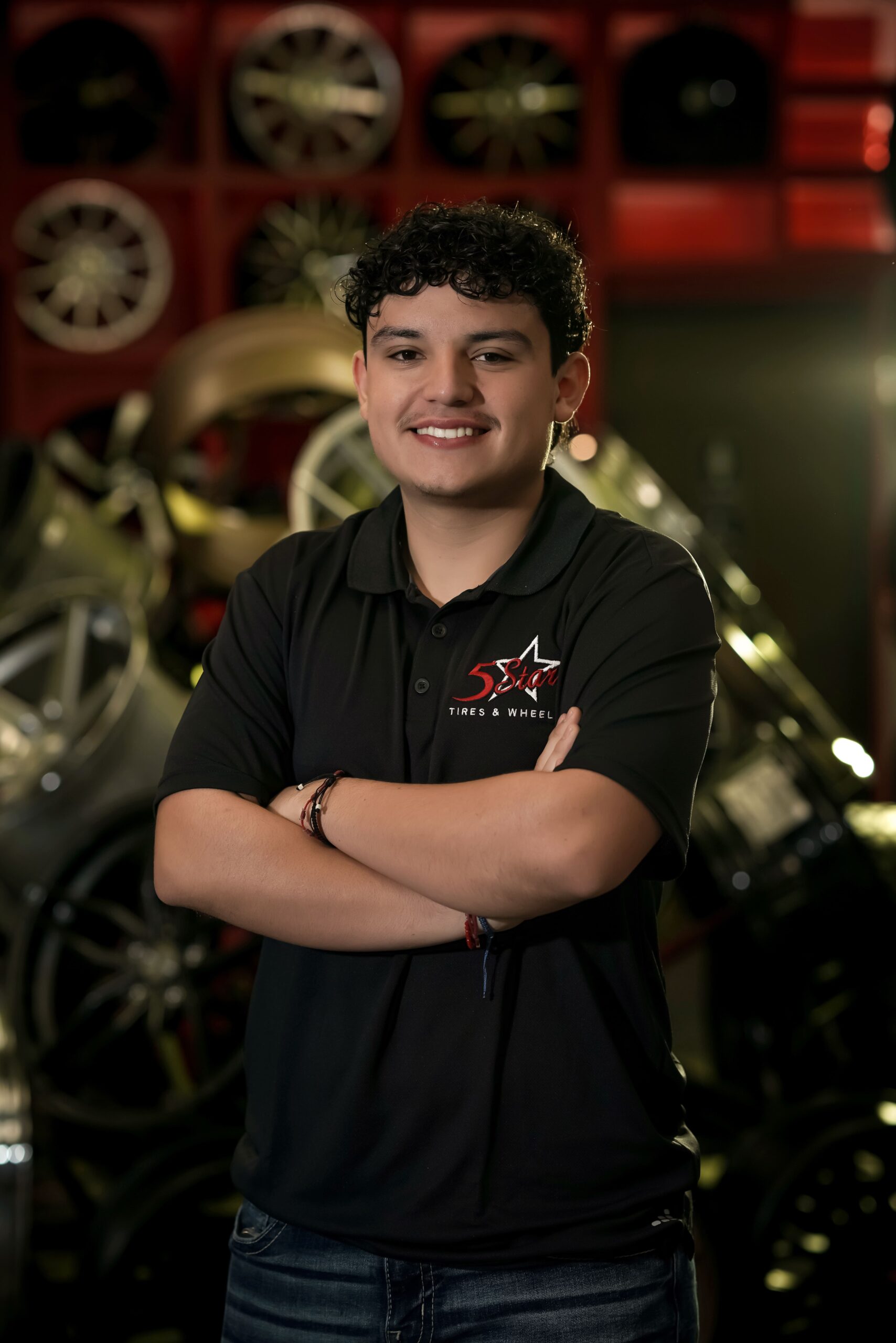 Friendly tire specialist at 5 Star Tires and Wheels, ready to assist customers.