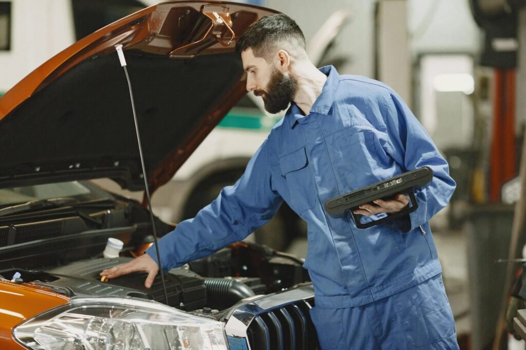 Mechanic inspecting engine after clutch replacement in a car at 770 Auto Service.