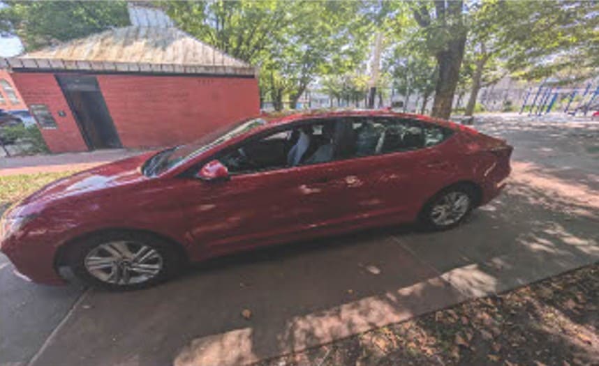 Red sedan parked outside 770 Auto Service, showcasing professional automotive repair and maintenance.