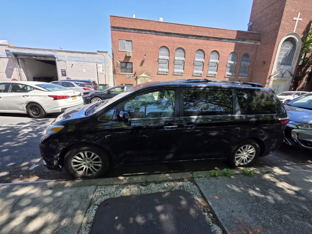 Auto service van parked on city street.