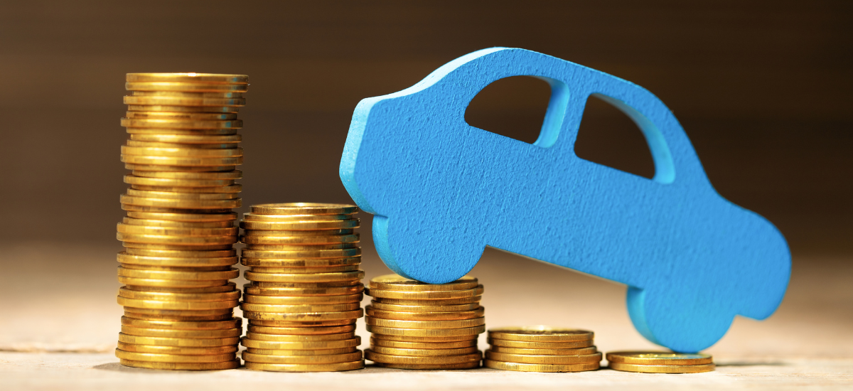 Blue toy car on stacked coins representing auto repair savings.