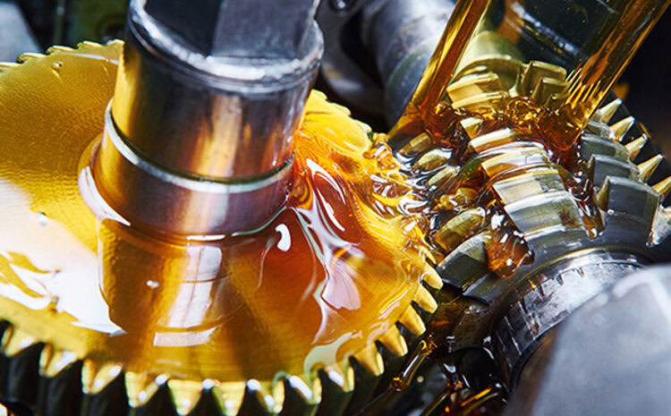 Close-up of gear mechanism with oil in an auto repair setting.