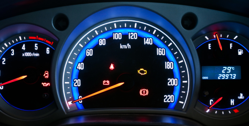 Vehicle dashboard with transmission warning lights illuminated.