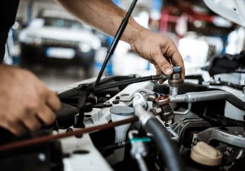 Expert transmission repair technician working on a vehicle's transmission system.