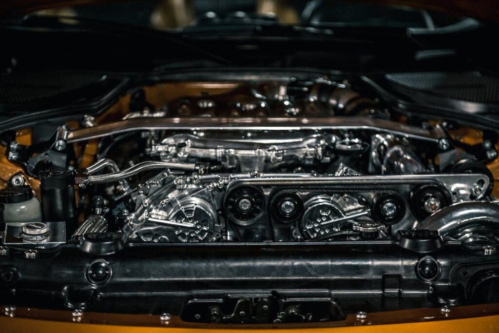 Transmission system components in a car engine bay.