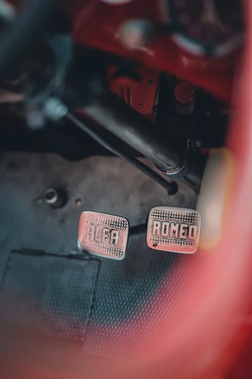 Close-up of brake and clutch pedals in a vehicle's interior.
