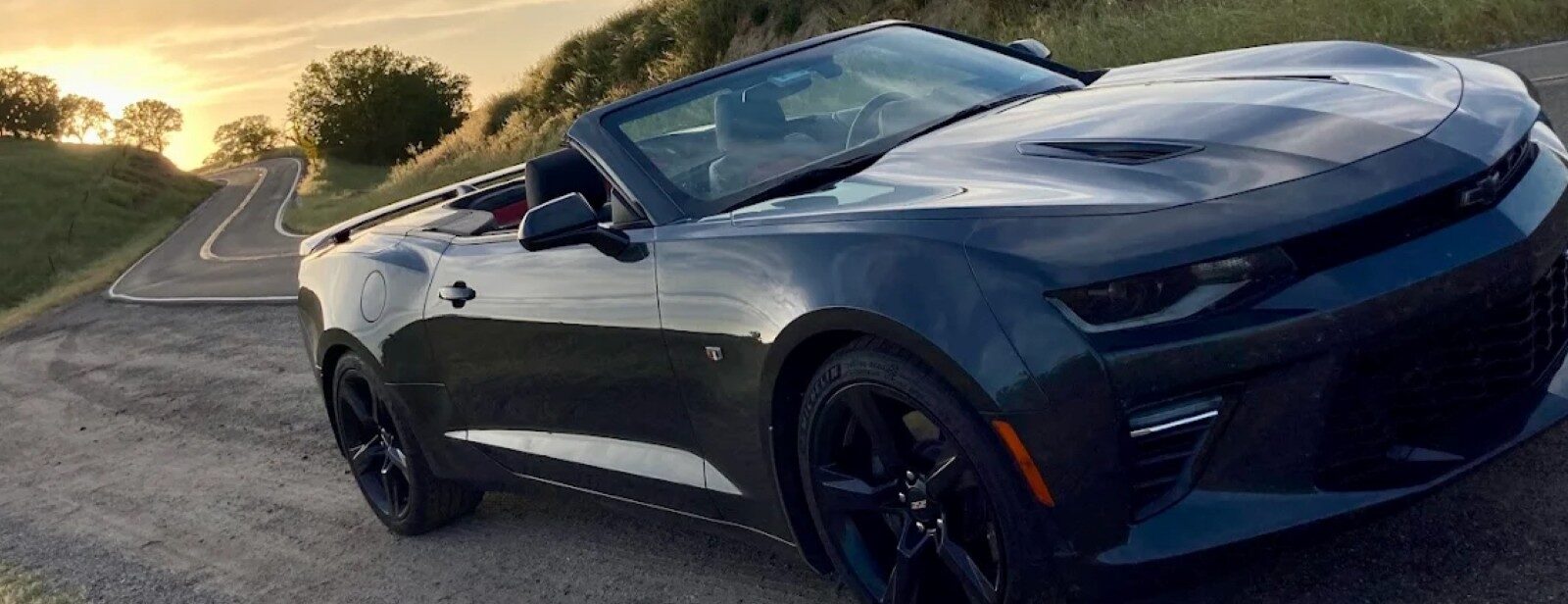 Black convertible sports car parked on a scenic road in Aliso Viejo, California. Perfect for stylish.