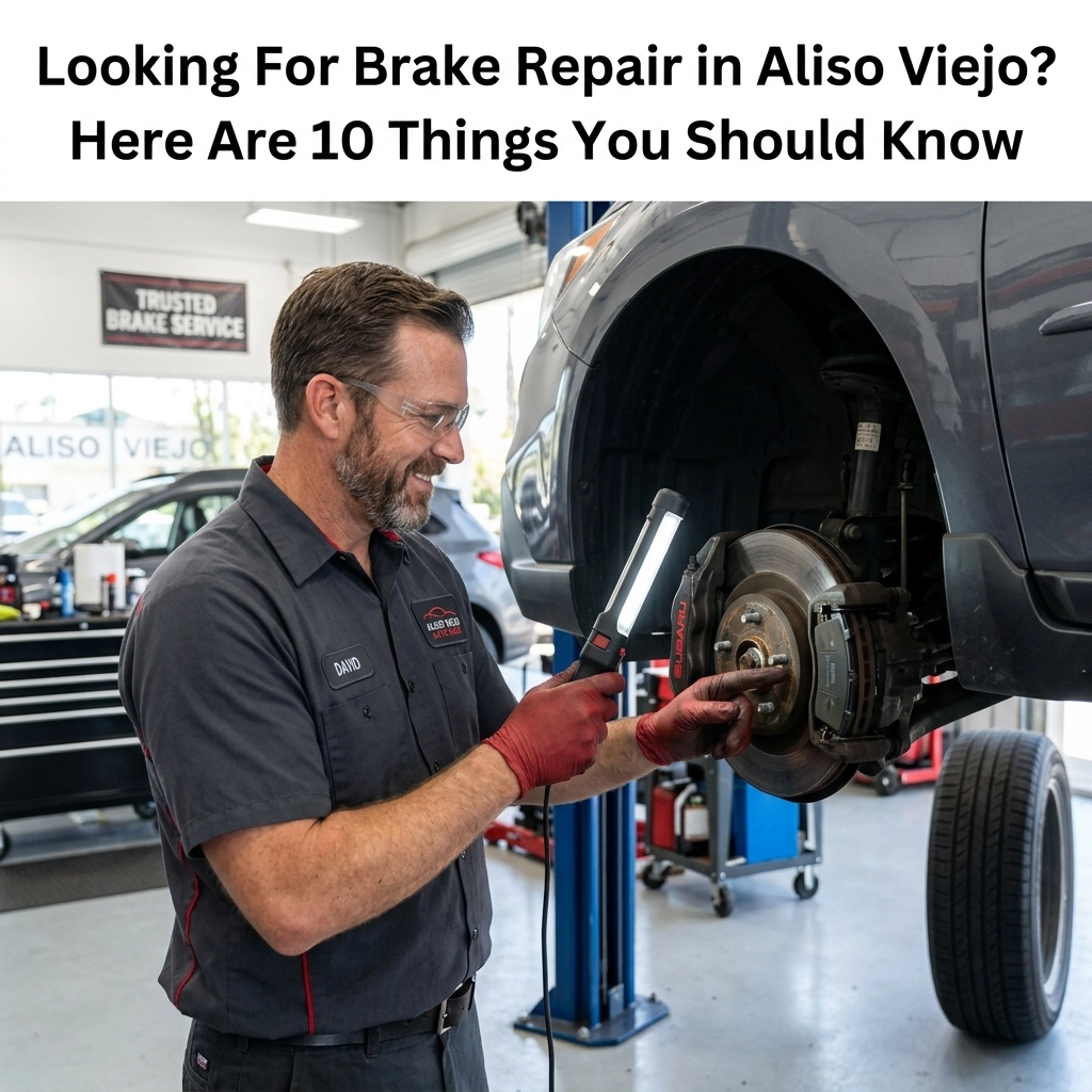 Auto mechanic inspecting brake system on vehicle in Aliso Viejo shop.