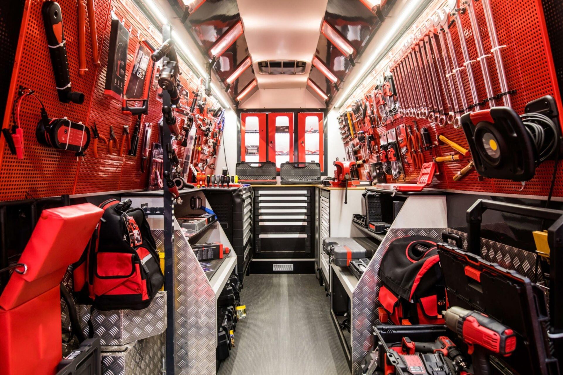 Emergency vehicle equipment storage interior with tools and gear.