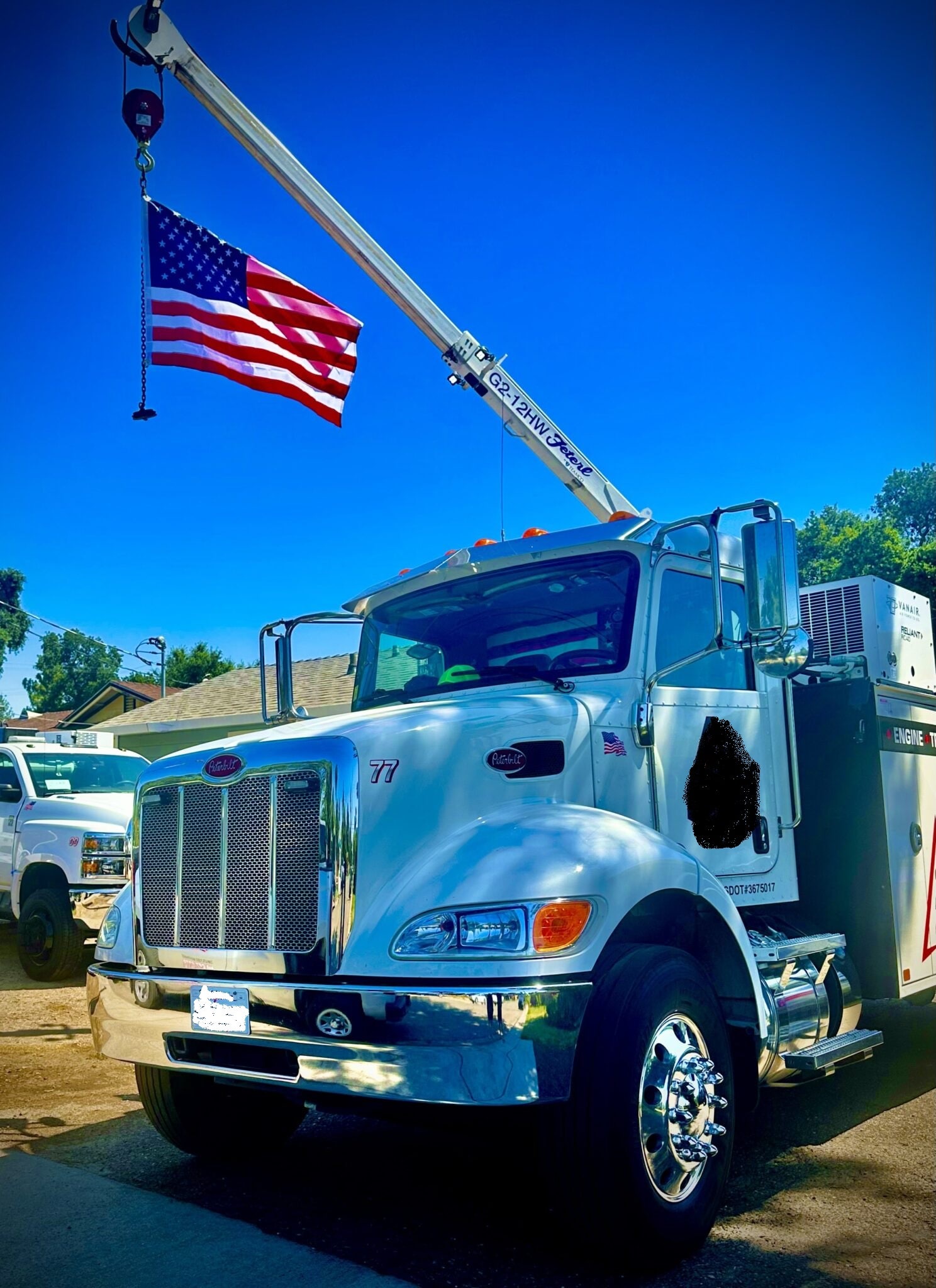 Emergency response truck with American flag, equipped for safety and rescue operations.