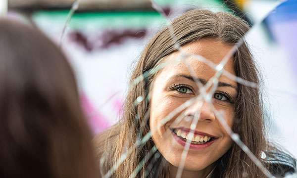 a-young-beautiful-woman-looks-at-her-reflection