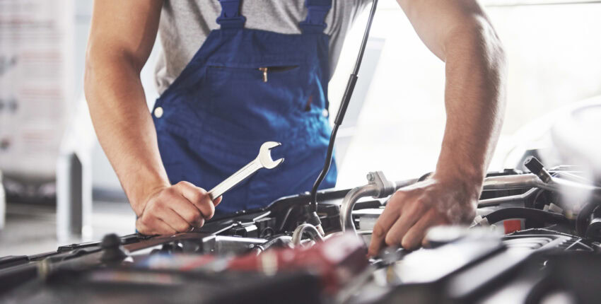Mechanic conducting engine repairs