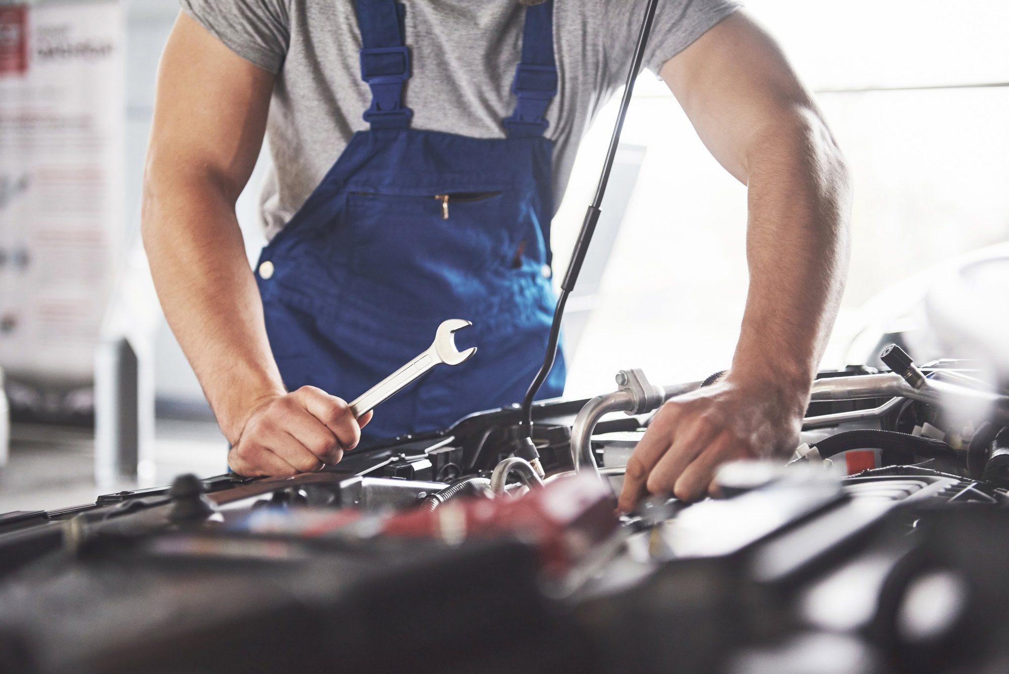 Mechanic conducting engine repairs