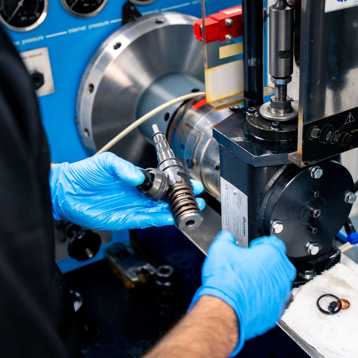 Technician performing engine diagnostics on a vehicle at Apex Automotive.