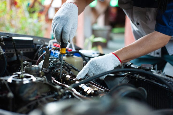 Engine repair, mechanic working on car engine, automotive maintenance, vehicle service.