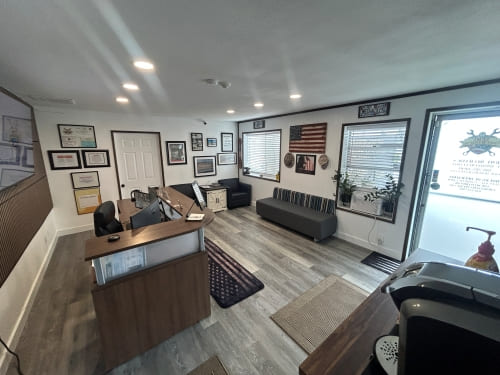 Modern office space featuring military memorabilia, framed photos, and patriotic accents.