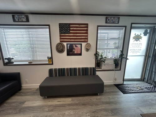 Military vehicle repair workshop interior with American flag decor.