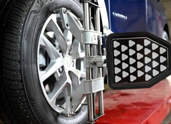 Tire alignment being performed on a vehicle at Army Mechanics Inc.