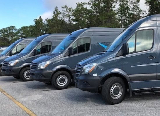 Fleet of maintenance vans parked outdoors for service and repair.