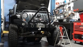 Heavy-duty off-road vehicle being serviced at Army Mechanics Inc. for reliable repair solutions.