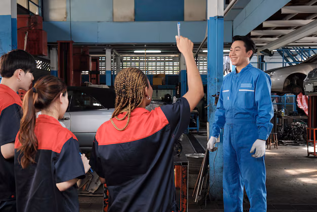 supervisor-engineer-is-teaching-mechanic-workers-about-car-engines-garage