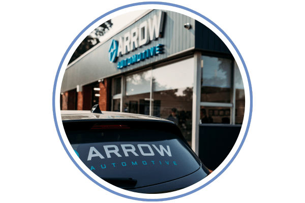 Auto repair shop with Arrow Automotive signage on building.
