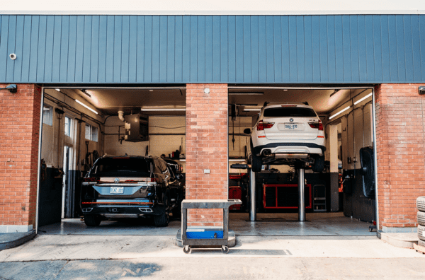 Auto repair garage with vehicles being serviced at Arrow Automotive.