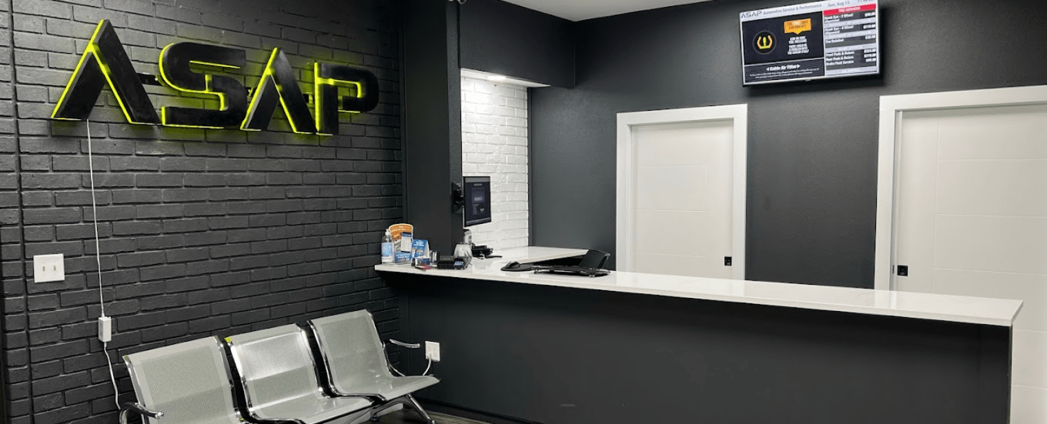 Automotive repair shop reception area with seating and service desk.