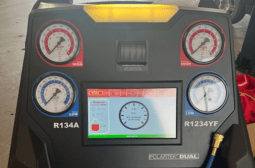 Automotive engine repair diagnostic tool with gauges and digital display.