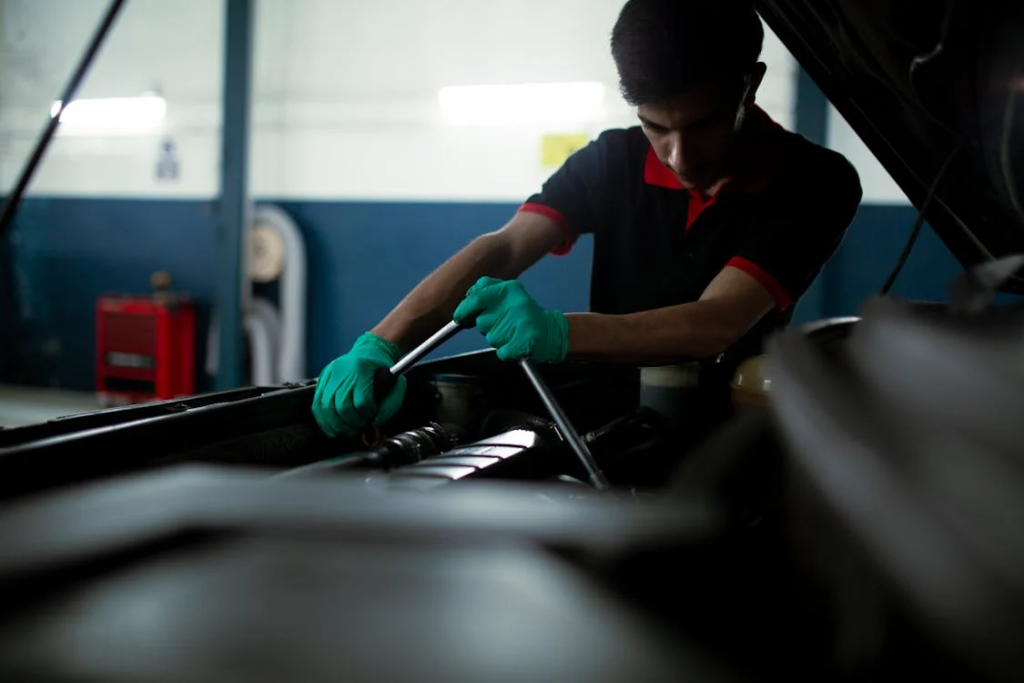 Professional mechanic inspecting engine filter for optimal engine performance.