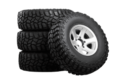 Stacked off-road tires with alloy wheels at ASAP Automotive & Transmission.