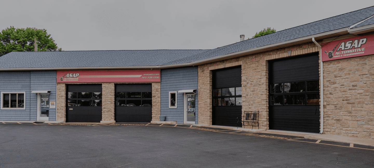 Exterior view of ASAP Automotive & Transmission shop with garage doors.
