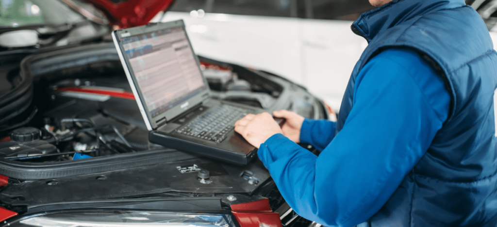 Technician performing vehicle diagnostics with a laptop at ASAP Automotive & Transmission.
