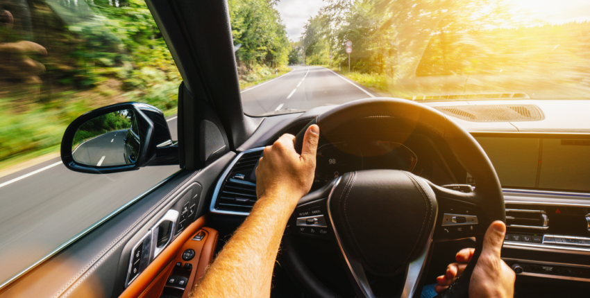 Auto repair technician inspecting a car dashboard on the road.