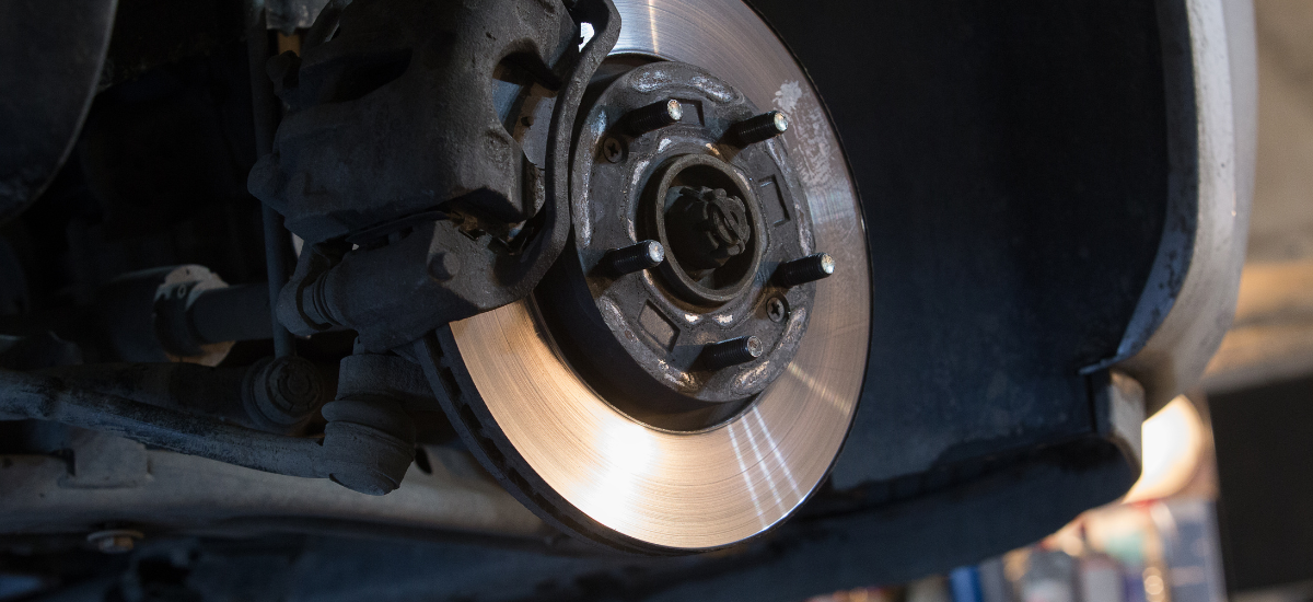 Brake system repair showing a close-up of a vehicle's brake disc and caliper.