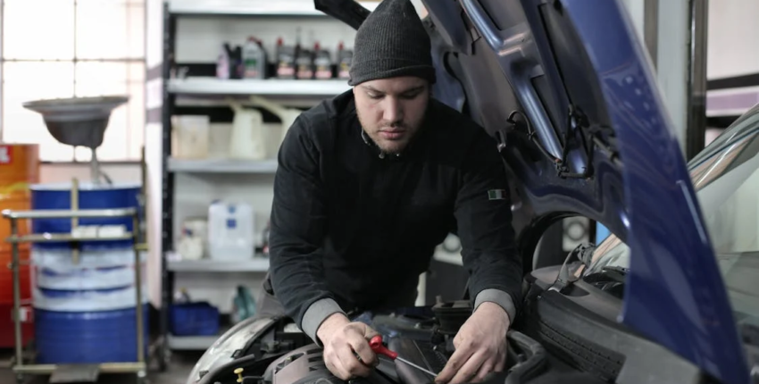 Suspension repair technician diagnosing vehicle suspension issues.
