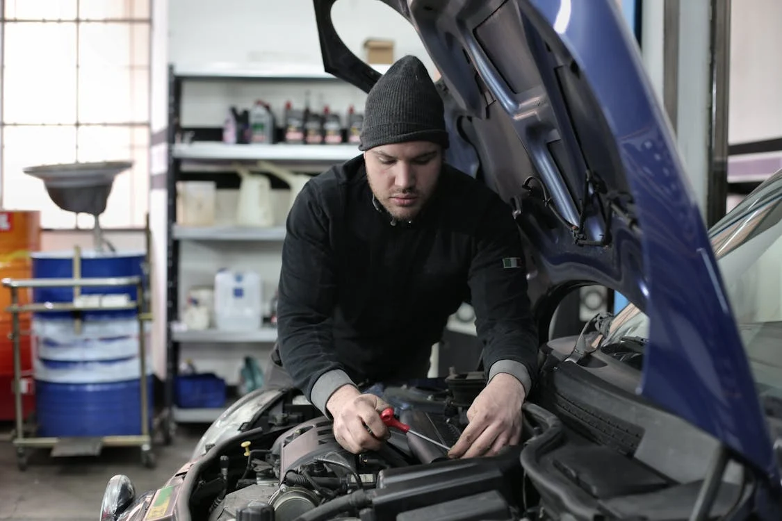 Suspension repair technician diagnosing vehicle suspension issues.