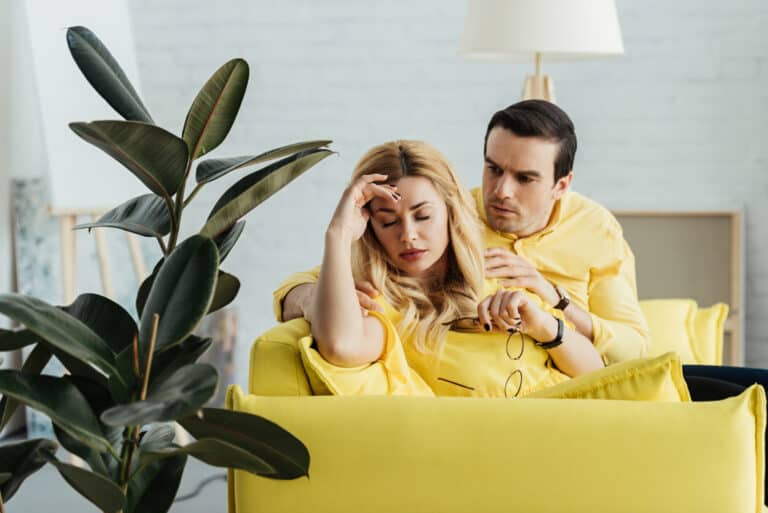upset couple on the couch. Sad / not talking.