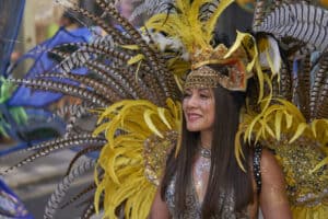Bath, England, United Kingdom - 9 July 2022: Dancers in ornate costumes performing at the annual carnival as it progresses through the streets of the historic city of Bath in Somerset.