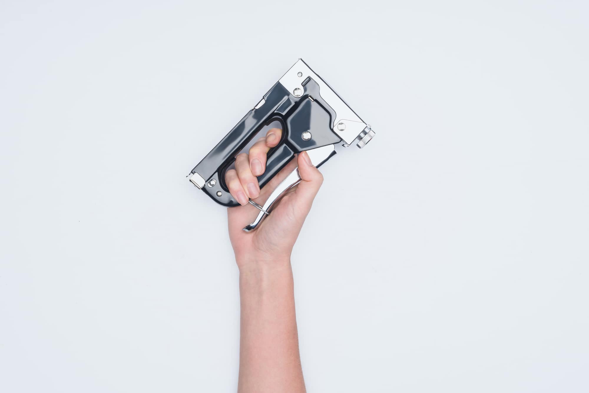 Cropped shot of woman holding stapler isolated on white