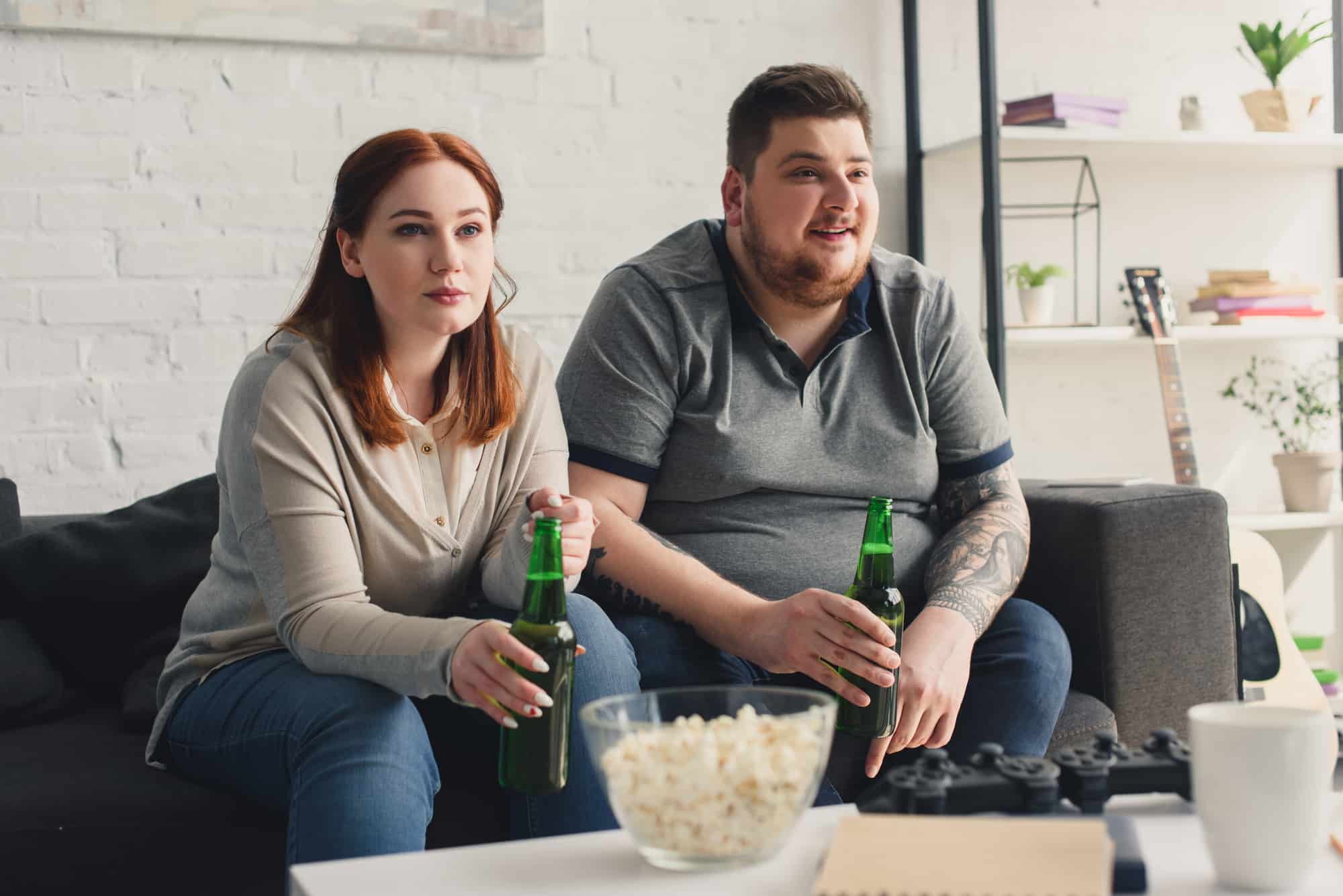 Overweight couple watching tv