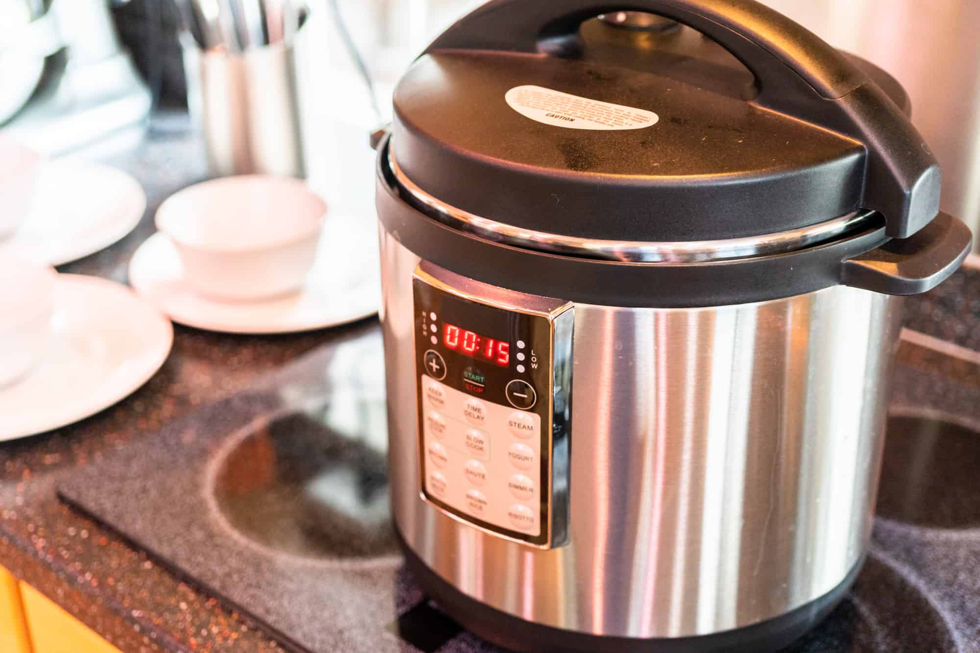 Cooking dinner in a pressure cooker in a modern kitchen. Instant pot.