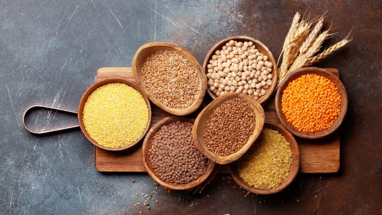 Gluten free cereals. Rice, buckwheat, corn groats, quinoa and millet in wooden bowls. Top view flat lay