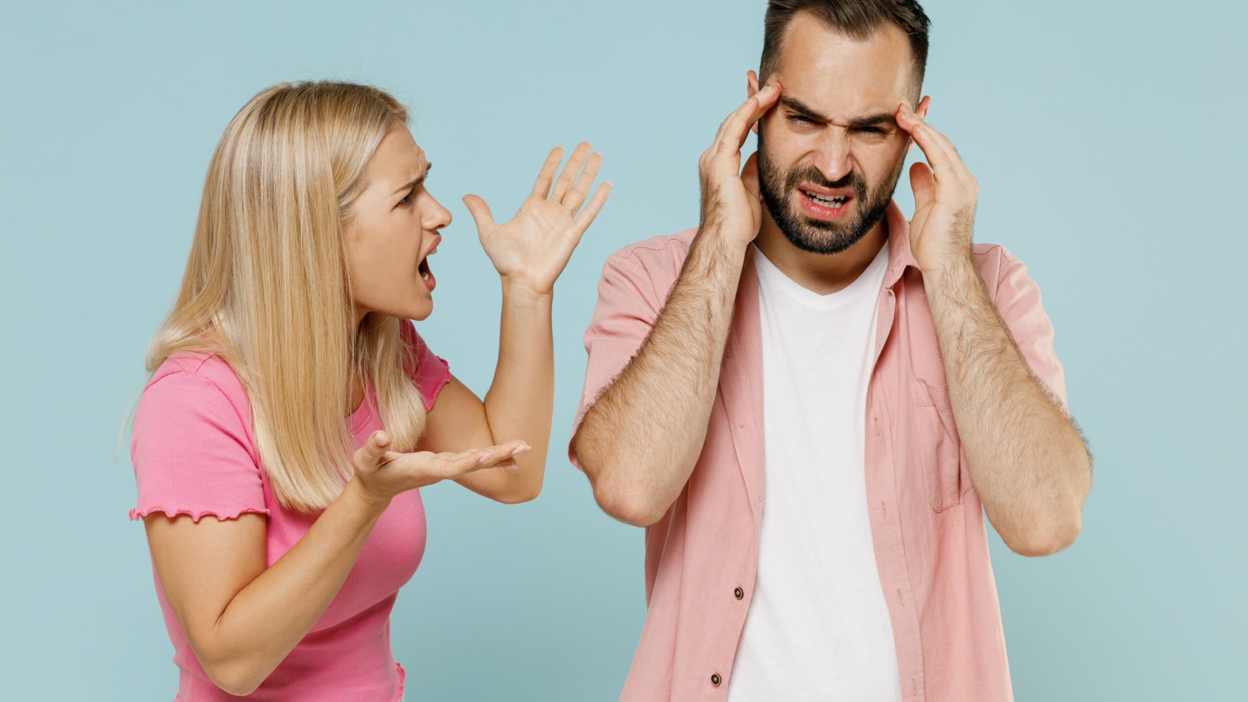 Young shouting sad couple two friends family man woman 20s in casual clothes screaming scolding together isolated on pastel plain light blue color background studio portrait People lifestyle concept