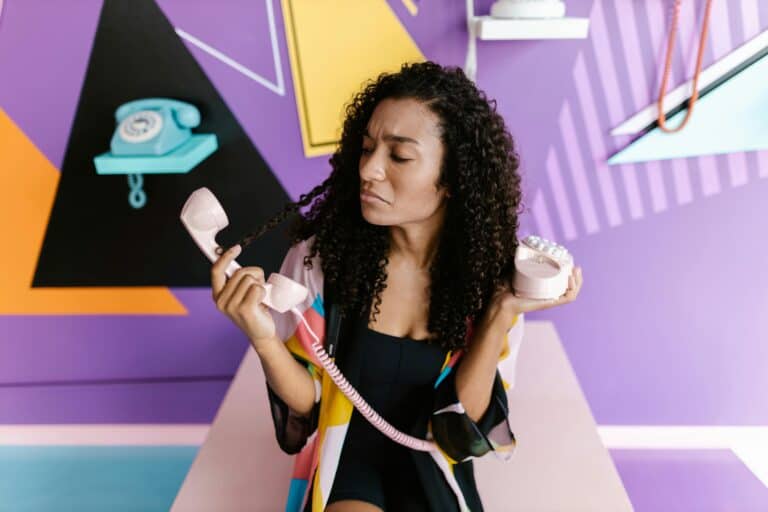 woman-holding-a-vintage-phone-and-making-a-surprised-face