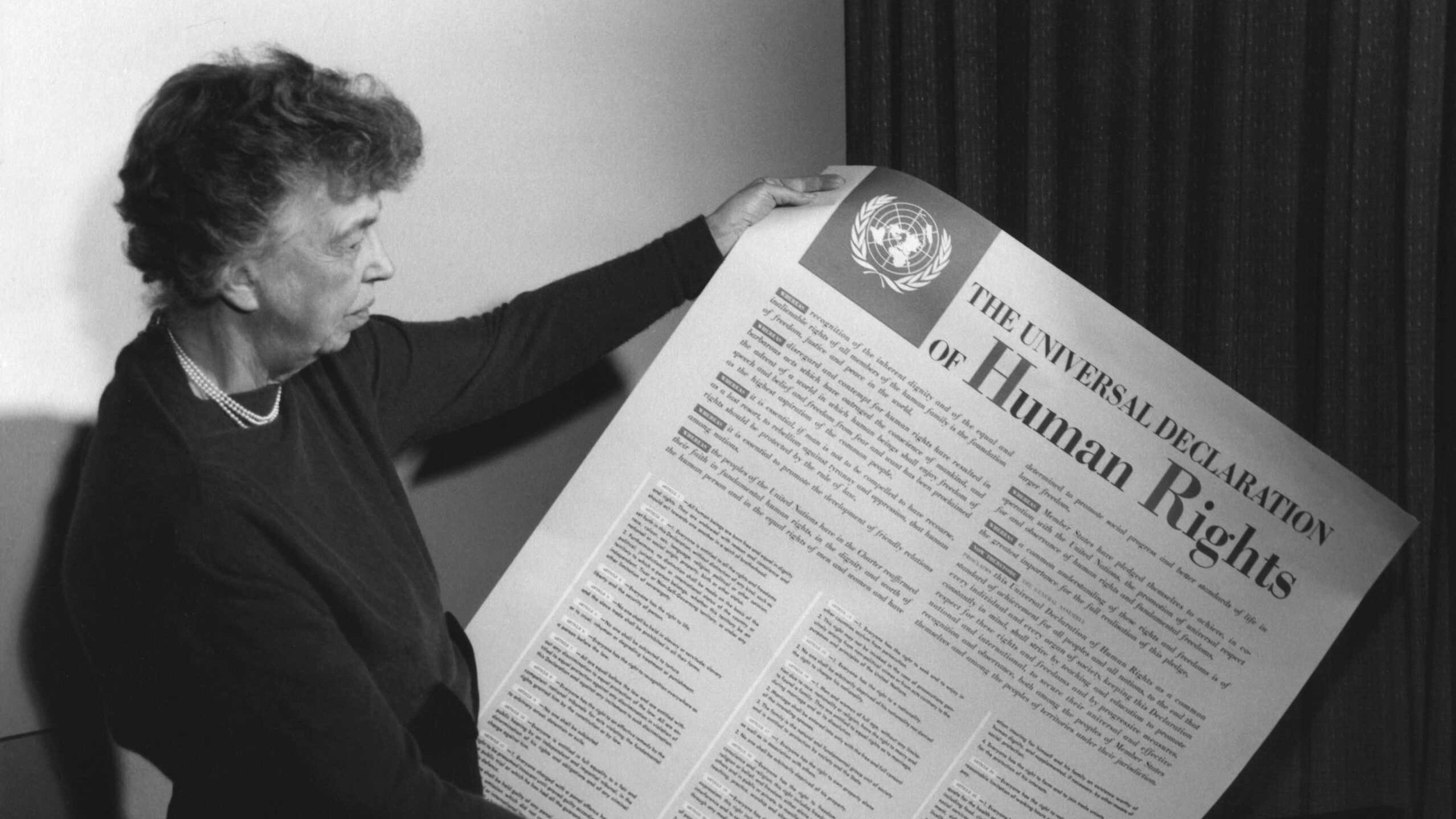Photo of Eleanor Roosevelt holding poster of the Universal Declaration of Human Rights