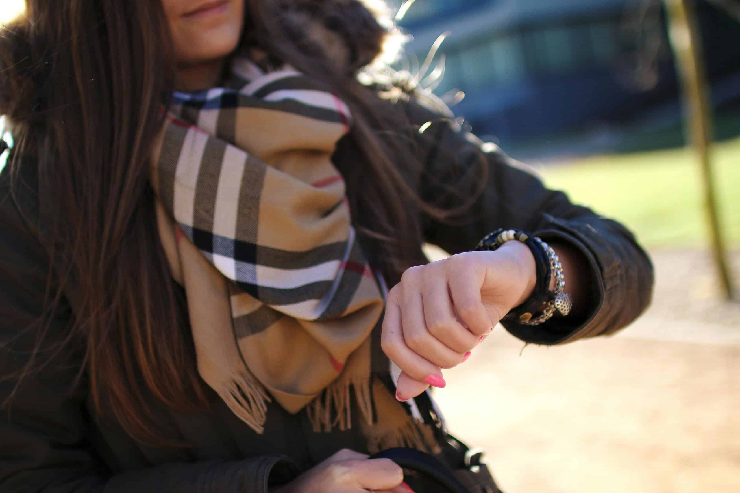 Cropped photo of woman checking her watch, time, clock