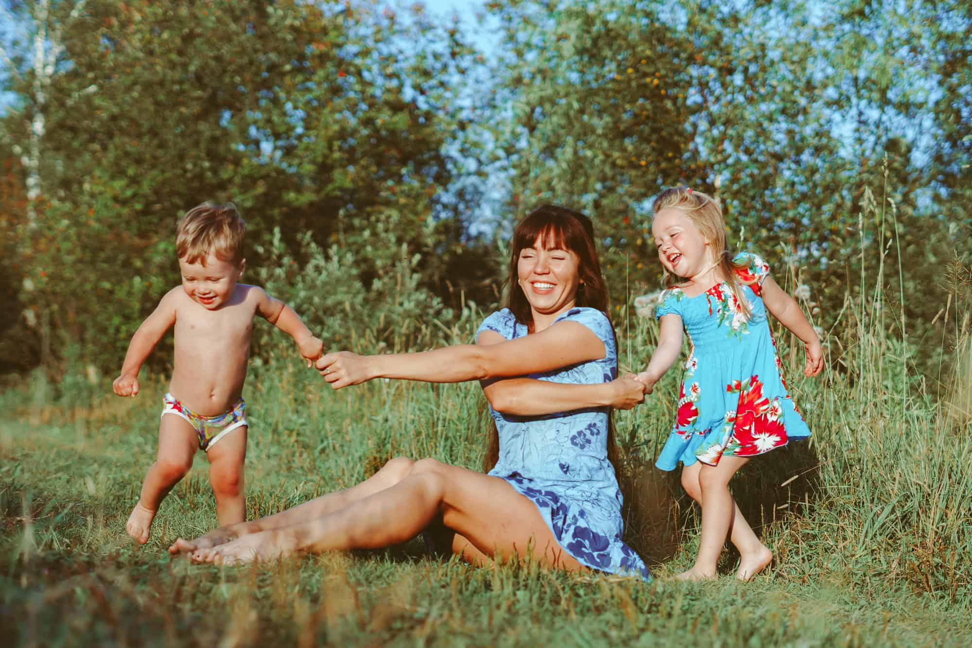 Woman with child having fun in summer park